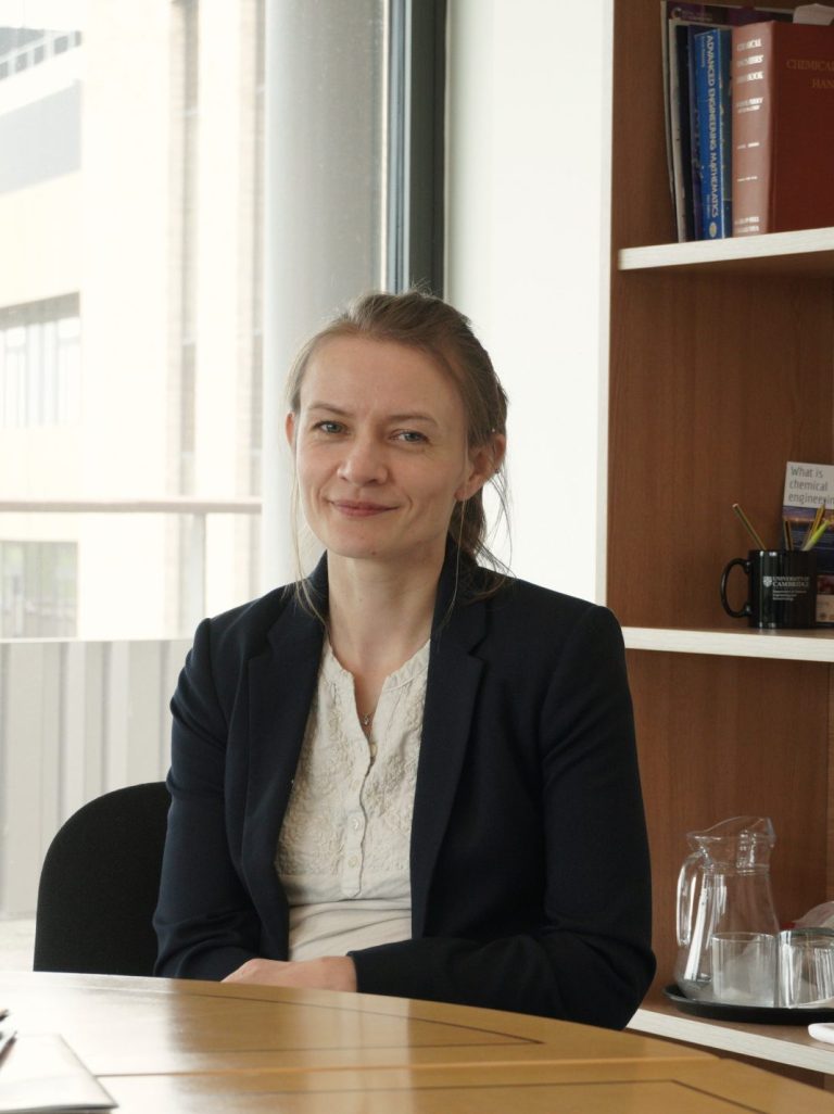 Eva Marek smiling at the camera in a desk style headshot.